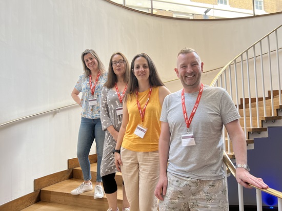 Delgegates standing on the stairs at conference: James Doherty, Natasha Hirst, Ann Galpin & Cristina Lago